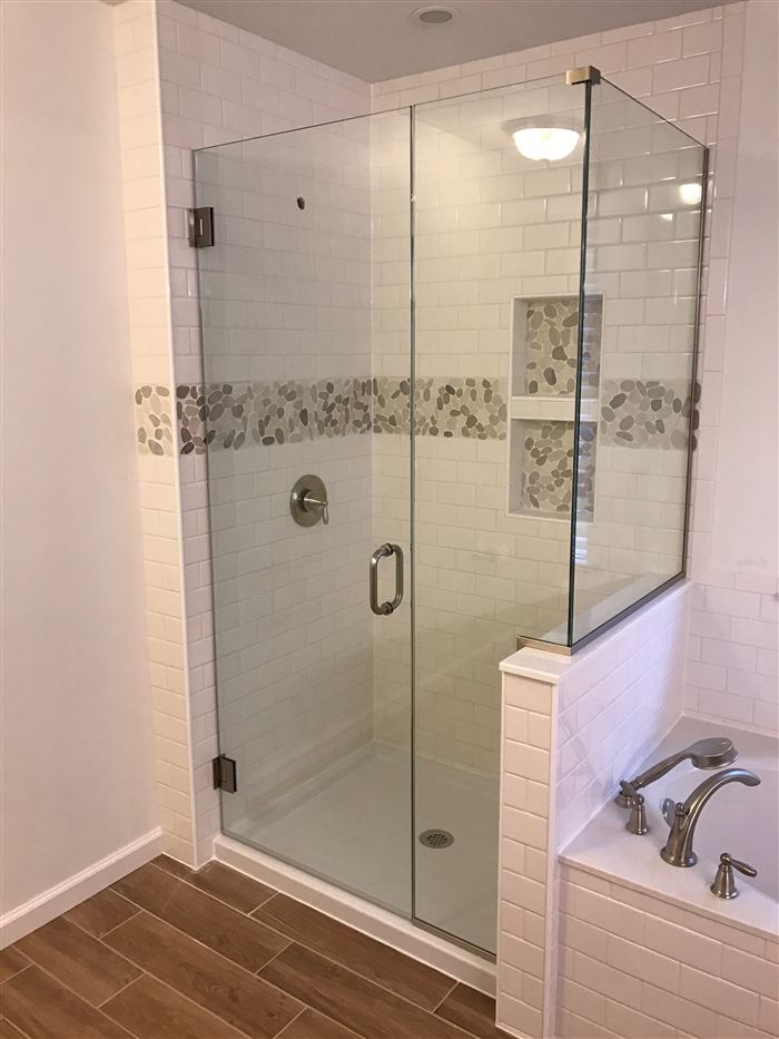Custom glass shower with tile accent band, bathroom remodel in Madison County Illinois