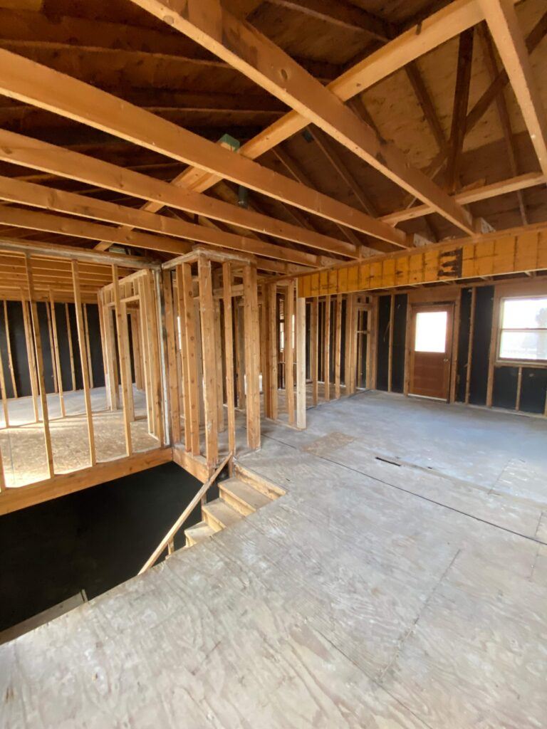 Exposed wood framing and roof structure during a Brunaugh Construction whole-home rebuild