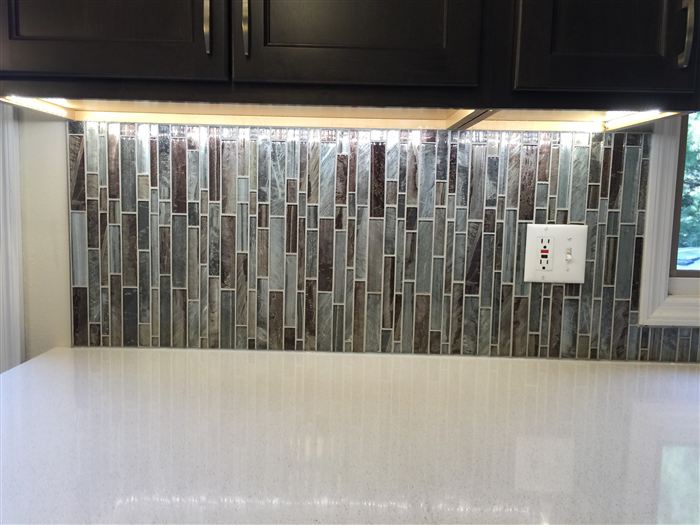 Finished glass tile backsplash and quartz counter detail