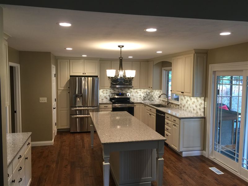 Remodeled kitchen with custom cream cabinetry, island, and hardwood floors in the Riverbend, Illinois