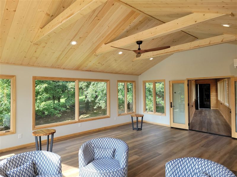 Vaulted wood-ceiling sunroom addition overlooking the water, Riverbend Illinois