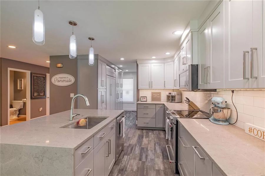 Waterfall-edge quartz island with prep sink — Wisteria Drive kitchen detail