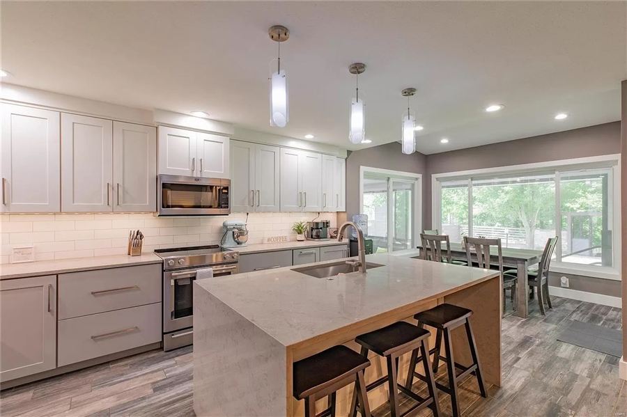Custom kitchen remodel with large island and pendant lighting — Wisteria Drive project by Brunaugh Construction & Design