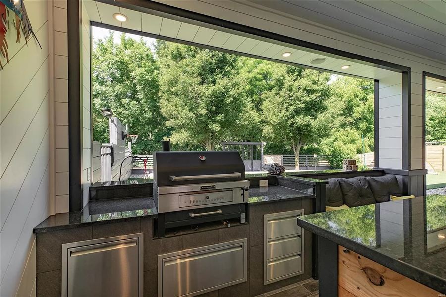 Built-in outdoor kitchen with grill and granite counters — Wisteria Drive